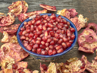 Delicious juicy red pomegranate.On wooden background