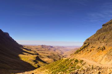 Fototapeta na wymiar Greenery in Sani pass under blue sky near kingdom of Lesotho Sou