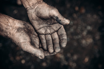 Obraz na płótnie Canvas Two palms in mud and calluses are pointing up, hands of refugee and homeless. Concept hard work