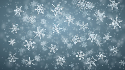 Christmas background of complex blurred and clear falling snowflakes in gray colors with bokeh effect
