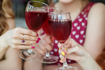 Glasses of red wine. Toast at a party. Concept of alcohol, holiday