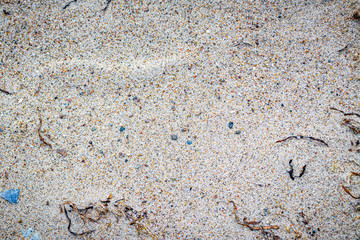 Sandy beach with colorful pebbles 