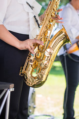 Gorgeous saxophonist lady is playing saxophone in wedding ceremony. musician woman. attractive woman and music instrument . classical and romantic happiness events. image for objects and copy space.
