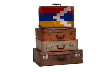 Artsakh travel concept. Group of vintage suitcases isolated on white background.