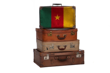 Cameroon, Cameroonian travel concept. Group of vintage suitcases isolated on white background.