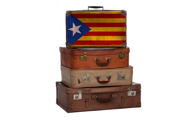 Catalonia, Spain travel concept. Group of vintage suitcases isolated on white background.