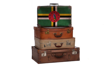 Dominica travel concept. Group of vintage suitcases isolated on white background.