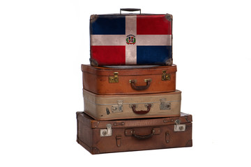 Dominican Republic travel concept. Group of vintage suitcases isolated on white background.