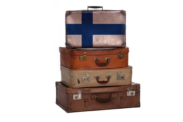 Finland, FInnish travel concept. Group of vintage suitcases isolated on white background.