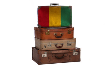 Guinea, Guinean travel concept. Group of vintage suitcases isolated on white background.
