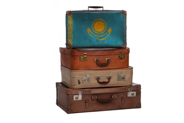 Kazakhstan, Kazakhstani travel concept. Group of vintage suitcases isolated on white background.