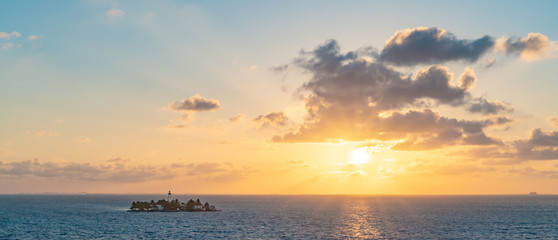 Sunset over small island with light house Belize 