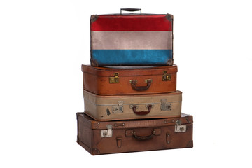 Luxembourg travel concept. Group of vintage suitcases isolated on white background.