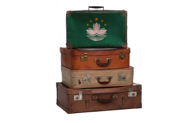 Macau, China travel concept. Group of vintage suitcases isolated on white background.