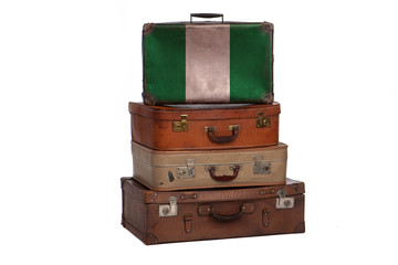 Nigeria, Nigerian travel concept. Group of vintage suitcases isolated on white background.