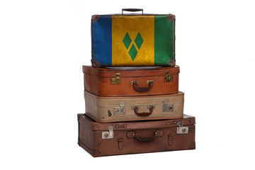 Saint Vincent and the Grenadines travel concept. Group of vintage suitcases isolated on white background.