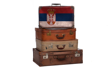 Serbia, Serbian travel concept. Group of vintage suitcases isolated on white background.