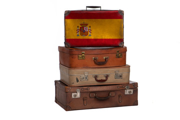 Spain, Spanish travel concept. Group of vintage suitcases isolated on white background.