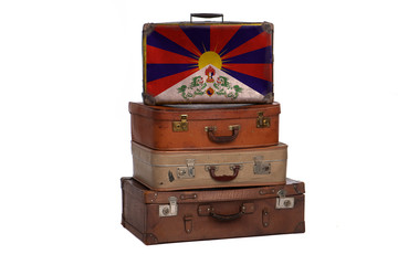 Tibet, Tibetan travel concept. Group of vintage suitcases isolated on white background.