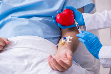 Male patient getting blood transfusion in hospital clinic