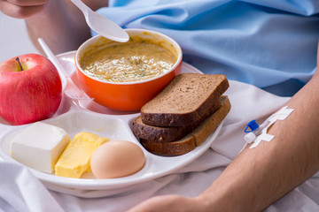 Male patient eating food in the hospital
