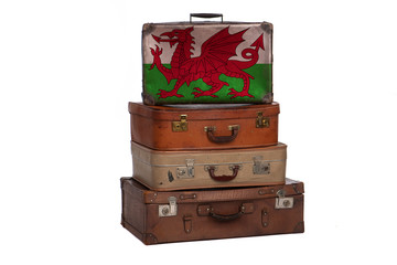 Wales, Welsh travel concept. Group of vintage suitcases isolated on white background.
