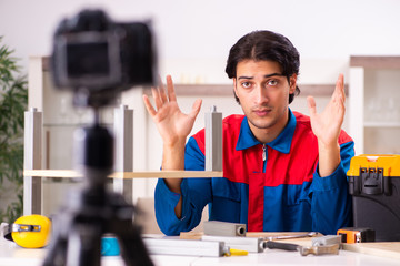 Young contractor recording video for his blog