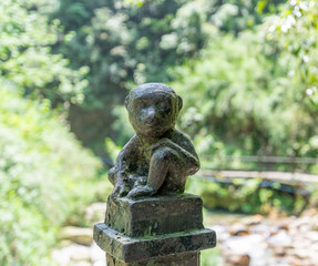 Monkey statue along the mountain road of Emei Mountain, China