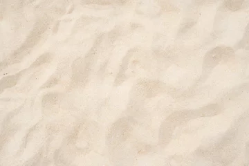 Fotobehang Strand zand textuur als achtergrond. © BUDDEE