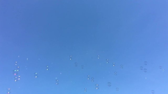 Bubble blowing against blue sky