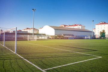 Training football field. Summer stadium and football game concept. Football field lighting. Lighting pillar with led technology.