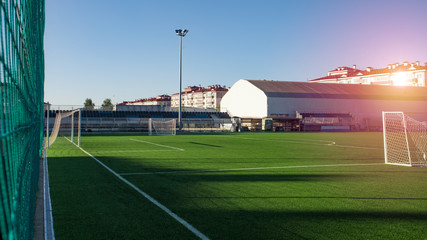 Naklejka premium Training football field. Summer stadium and football game concept. Football field lighting. Lighting pillar with led technology.