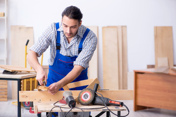Young male carpenter working indoors