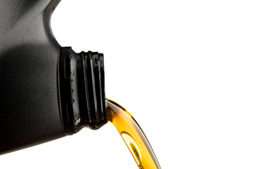 Pouring oil lubricant motor car from black bottle on isolated white background