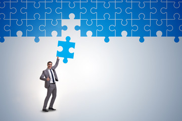 Concept of businessman with missing jigsaw puzzle piece