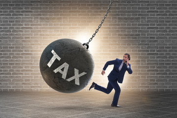 Businessman running away from high taxes