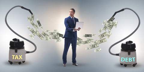 Businessman and vacuum cleaner sucking money out of him