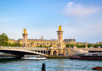 A view of the Pont Alexandre III bridge that spans the Seine River in Paris, France