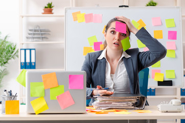 Young female employee in conflicting priorities concept