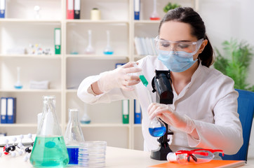 Young female chemist working in the lab