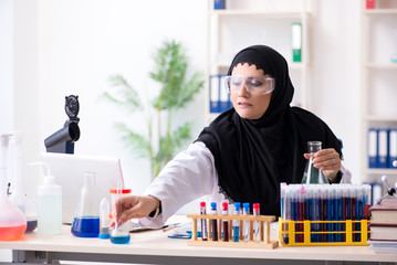 Female chemist in hijab working in the lab