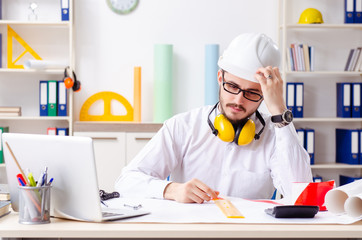 Young male architect working in the office