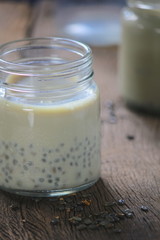 black sesame soy milk in glass on wood