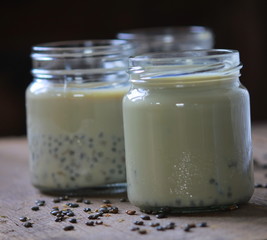 black sesame soy milk in glass on wood