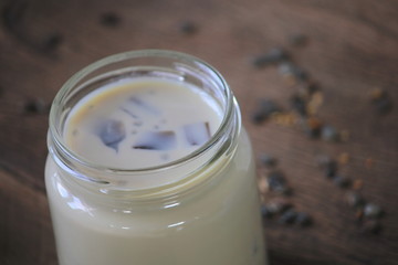 black sesame soy milk in glass on wood