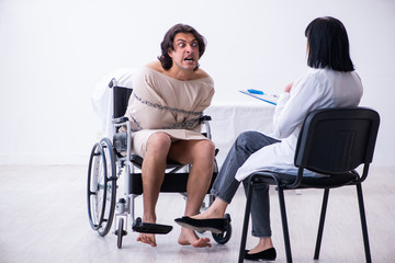 Obraz na płótnie Canvas Old female psychiatrist visiting young male patient