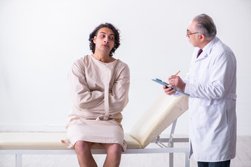 Aged male doctor psychiatrist examining young patient