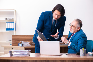 Young and old employees working together in the office