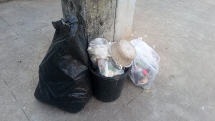 The garbage is placed on the footpath of the road to wait for the garbage truck to collect.