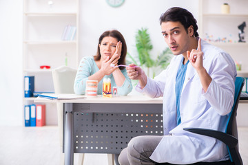 Middle-aged woman visiting male doctor stomatologist